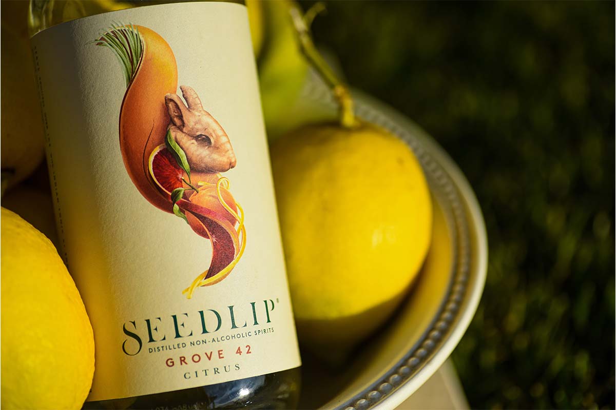 A bottle of non-alcoholic Seedlip and some lemons in a basket. Non-alcoholic drinks consumption grew during Dry January.