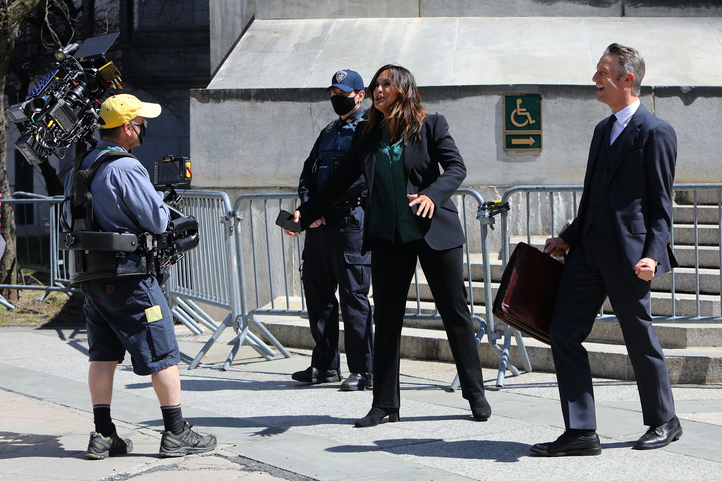 Mariska Hargitay and Peter Scanavino chat with a cameraman on the set of "Law and Order: Special Victims Unit" in 2021