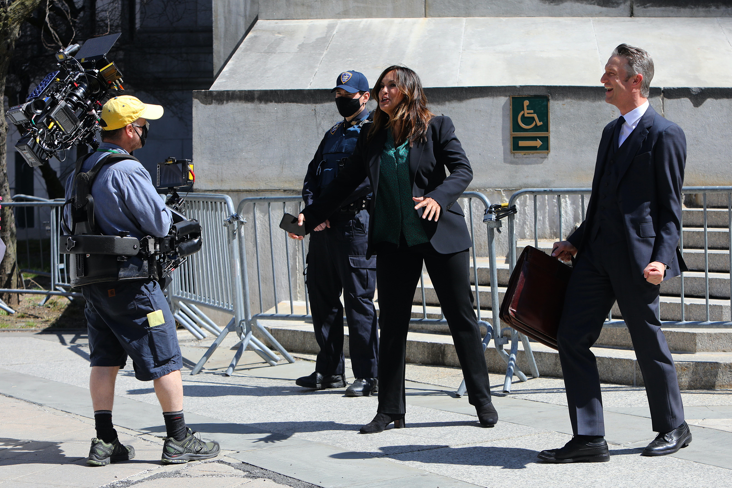 Mariska Hargitay and Peter Scanavino chat with a cameraman on the set of "Law and Order: Special Victims Unit" in 2021 