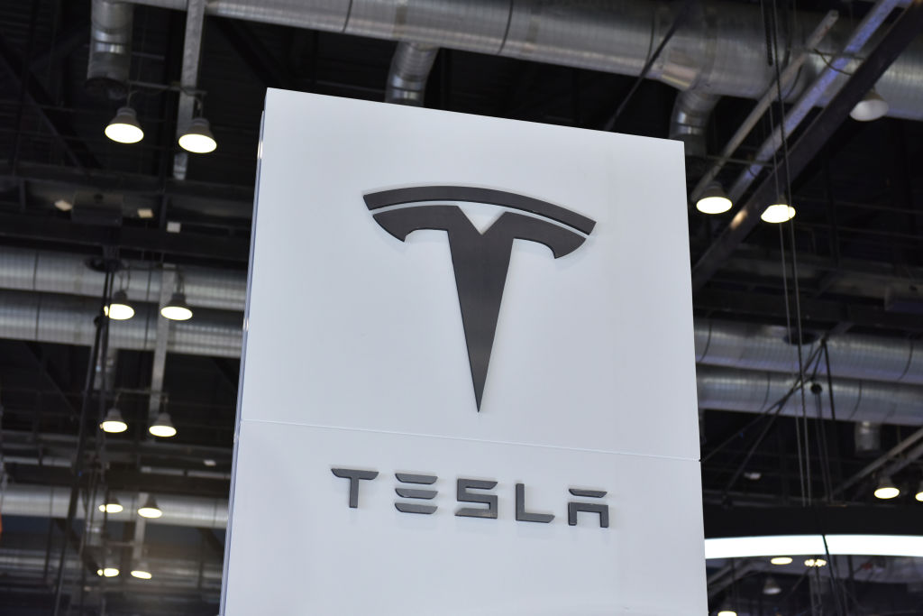 A Tesla logo on a sign. According to Tesla, the California Department of Fair Employment and Housing notified Elon Musk's EV maker that it could file a civil complaint against the company due to accusations of racism.