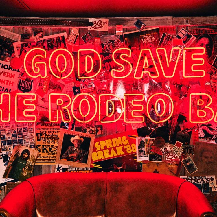 A neon sign "God Save the Rodeo Bar"