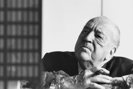 Architect Mies van der Rohe in a black and white photograph. In the 1950s, he designed a frat house. In 2022, that design opened at Indiana University.