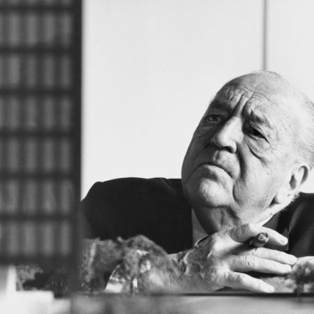 Architect Mies van der Rohe in a black and white photograph. In the 1950s, he designed a frat house. In 2022, that design opened at Indiana University.