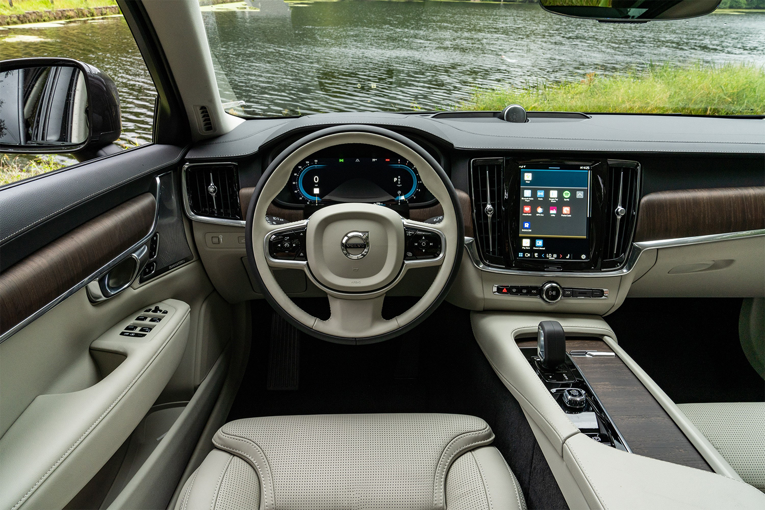 The driver's seat in the 2022 Volvo V90 Cross Country, showing the steering wheel, gauge cluster and infotainment