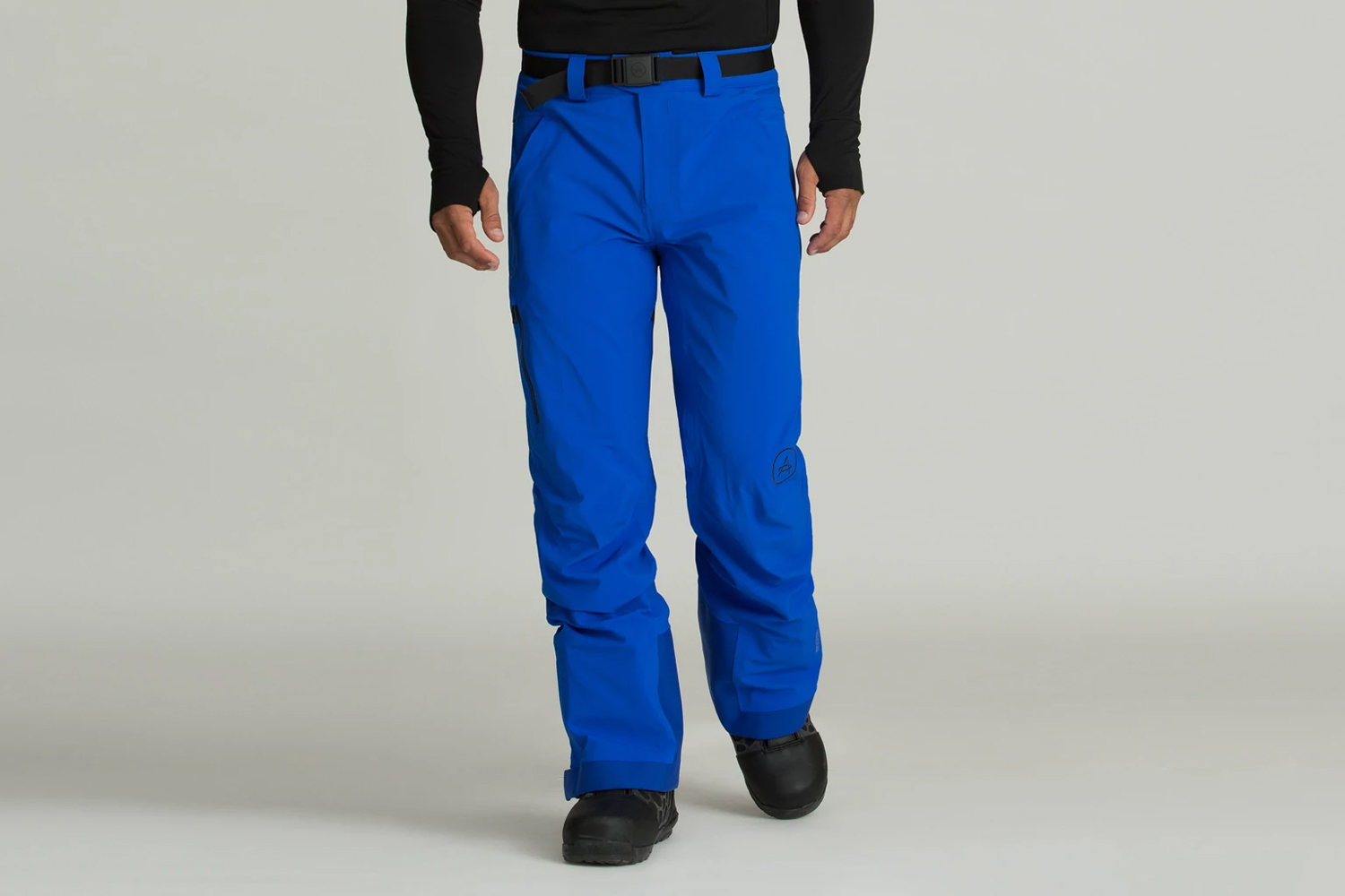 Aether Approach Snow Pant in bright blue on a beige background