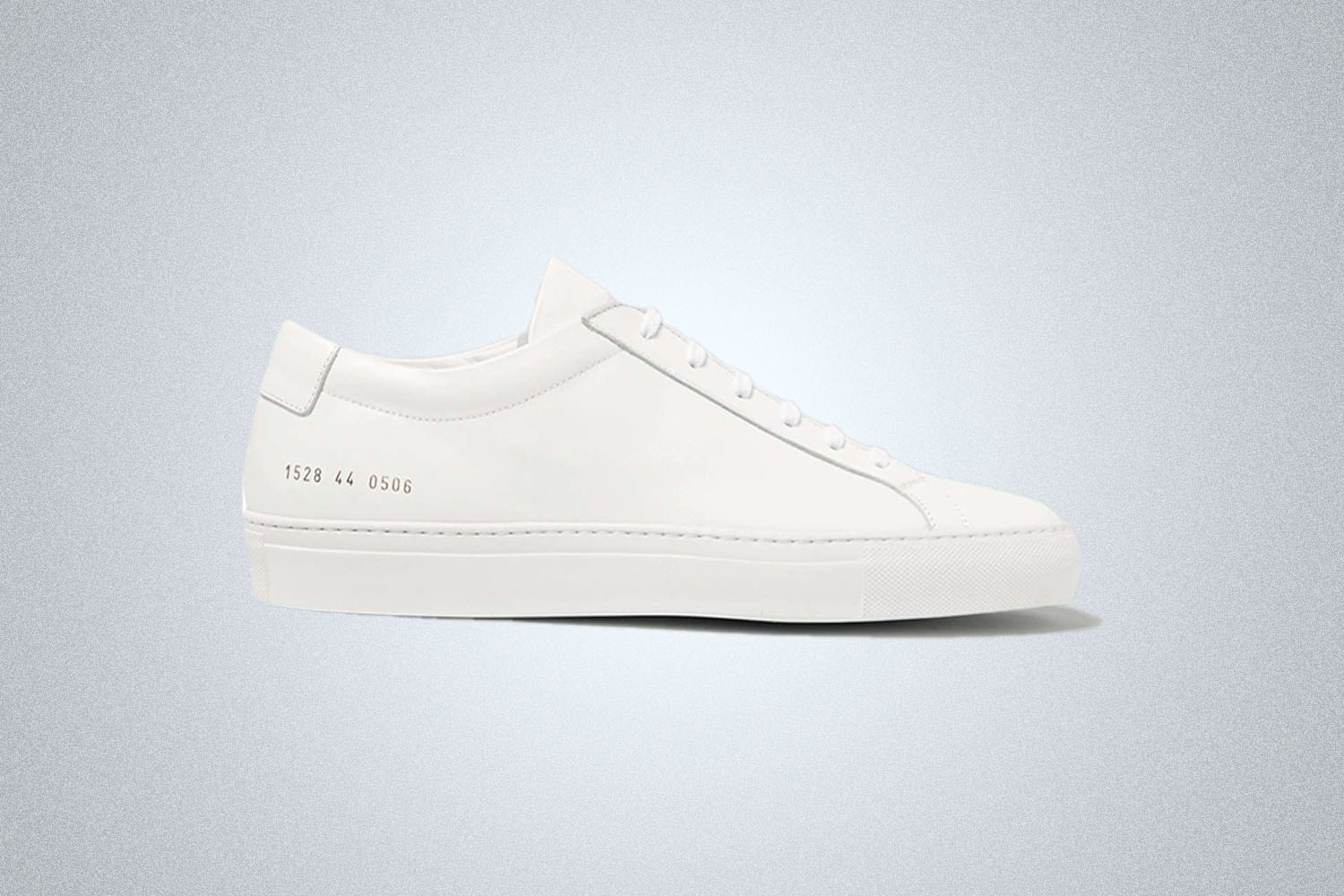 a white shoe on a light grey background