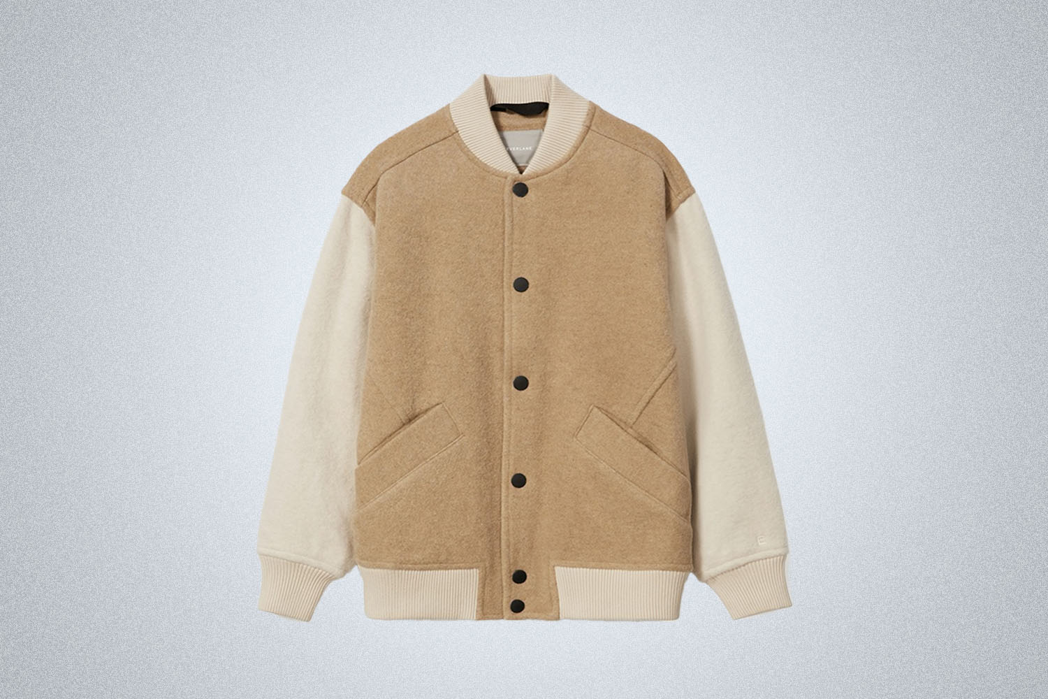 An Everlane Bomber Jacket on a grey background
