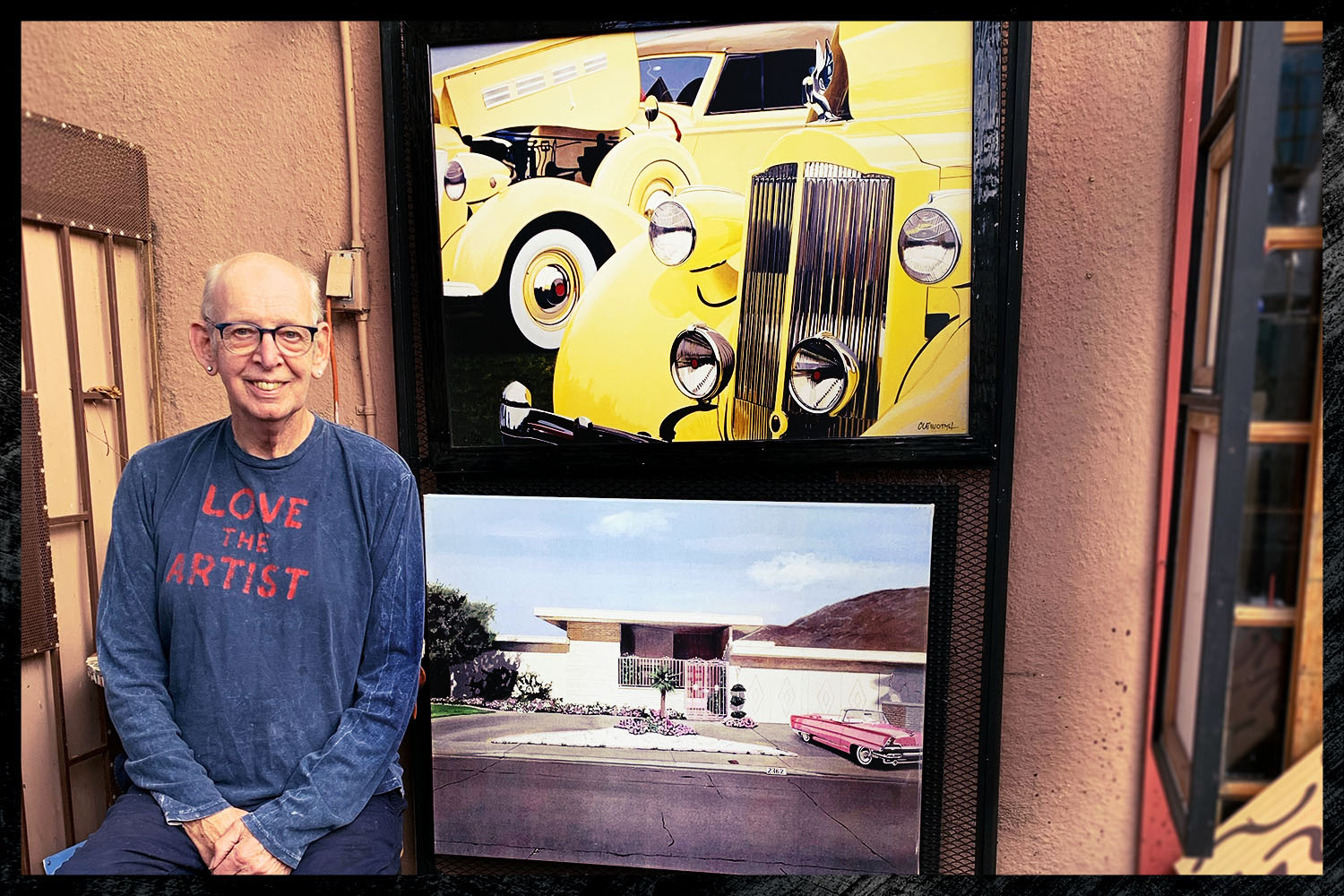 Painter Harold Cleworth, from Manchester, UK, but living in Venice Beach, California, sitting next to two paintings of cars. He's known for painting classic cars for their well-heeled owners.