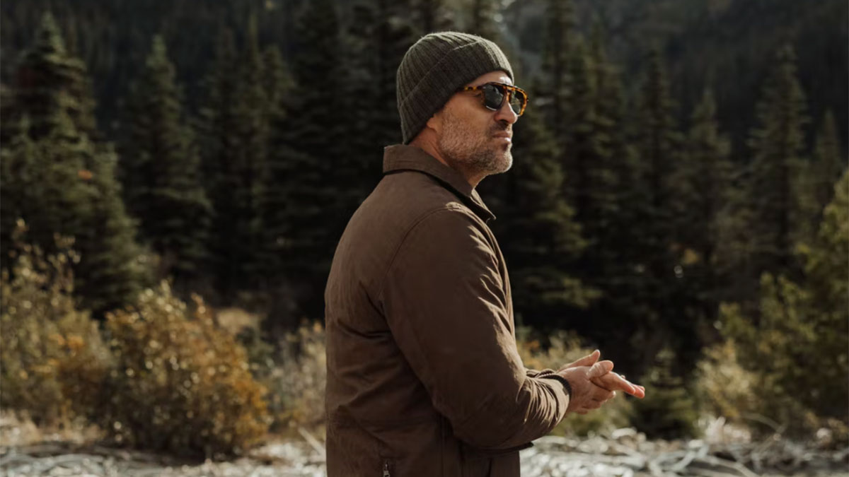 a man in a sweater and sunglasses