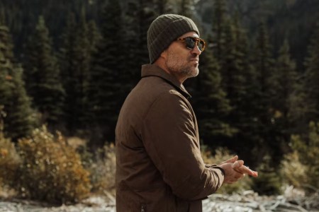 a man in a sweater and sunglasses