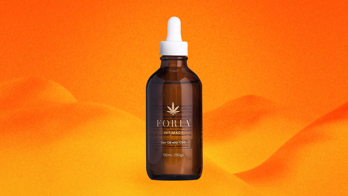 A bottle of Foria'sIntimacy Sex Oil with CBD on an orange background