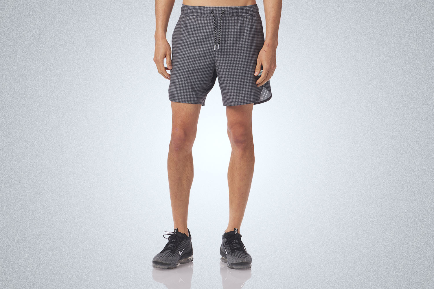 a pair of grey mesh shorts on a grey background 