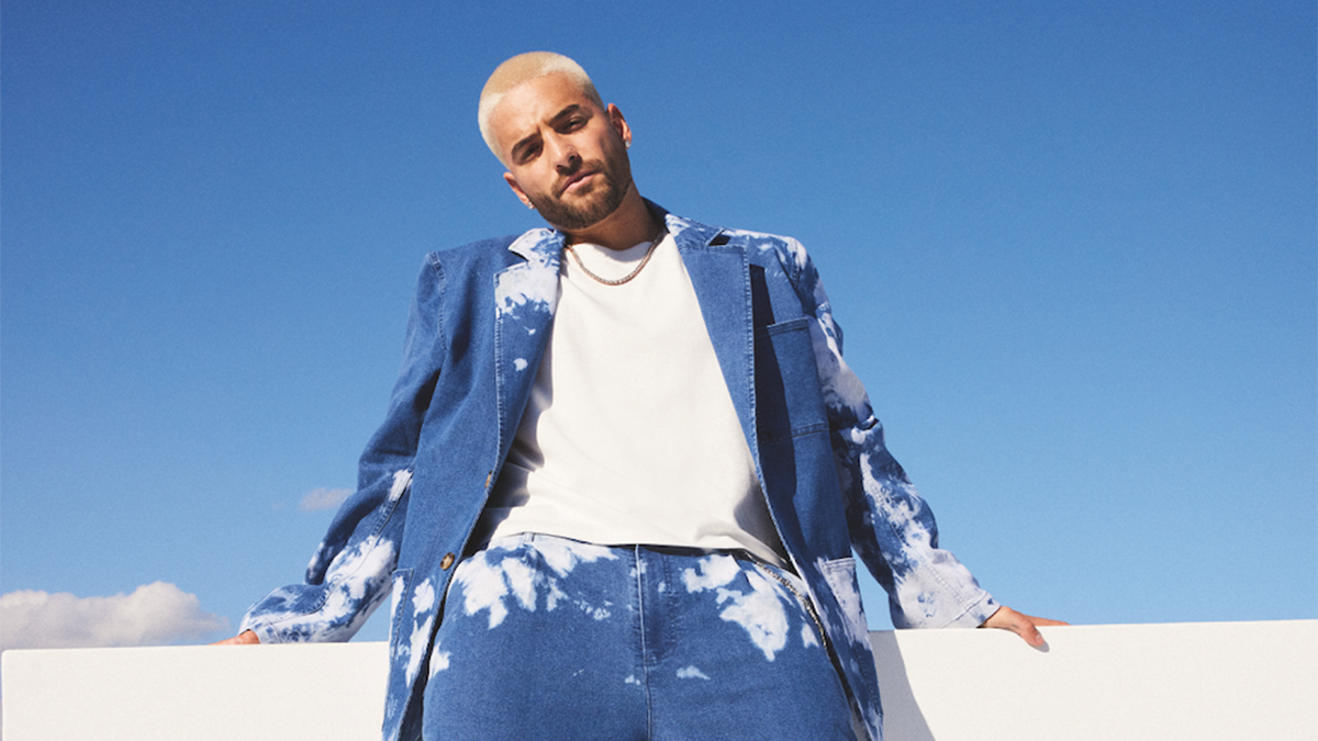 Maluma standing in front of a blue sky