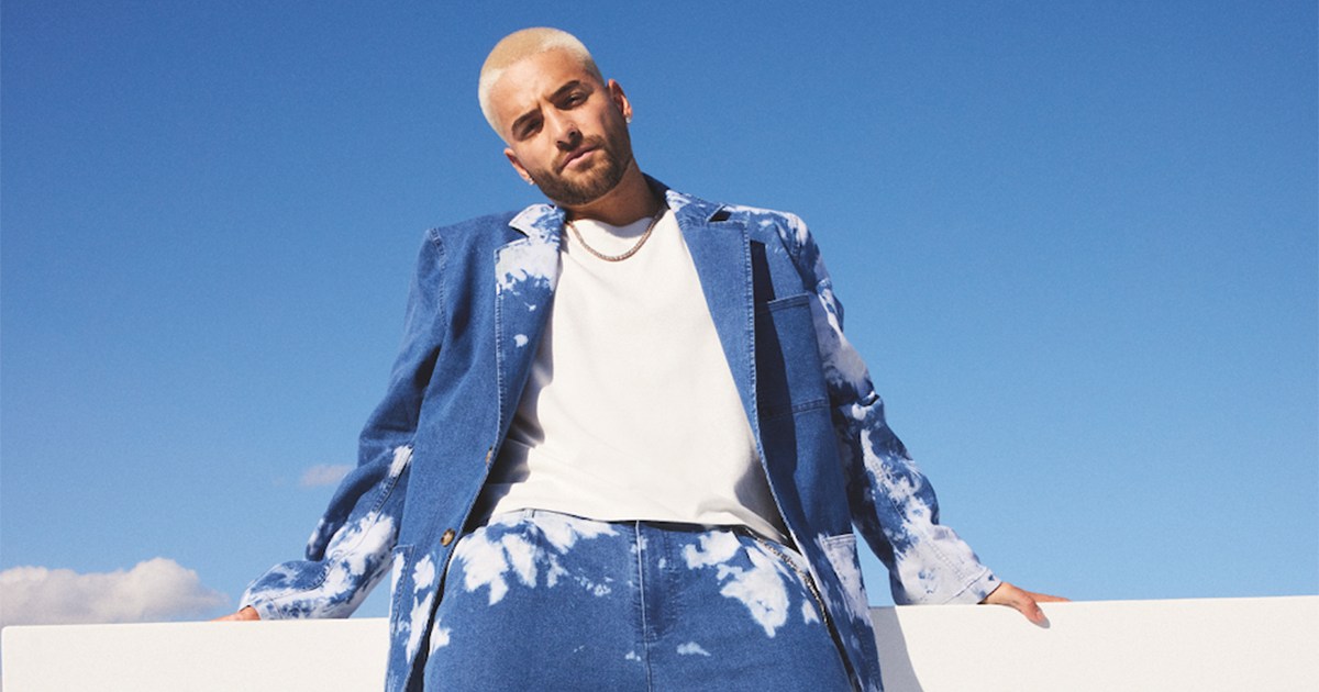 Maluma standing in front of a blue sky
