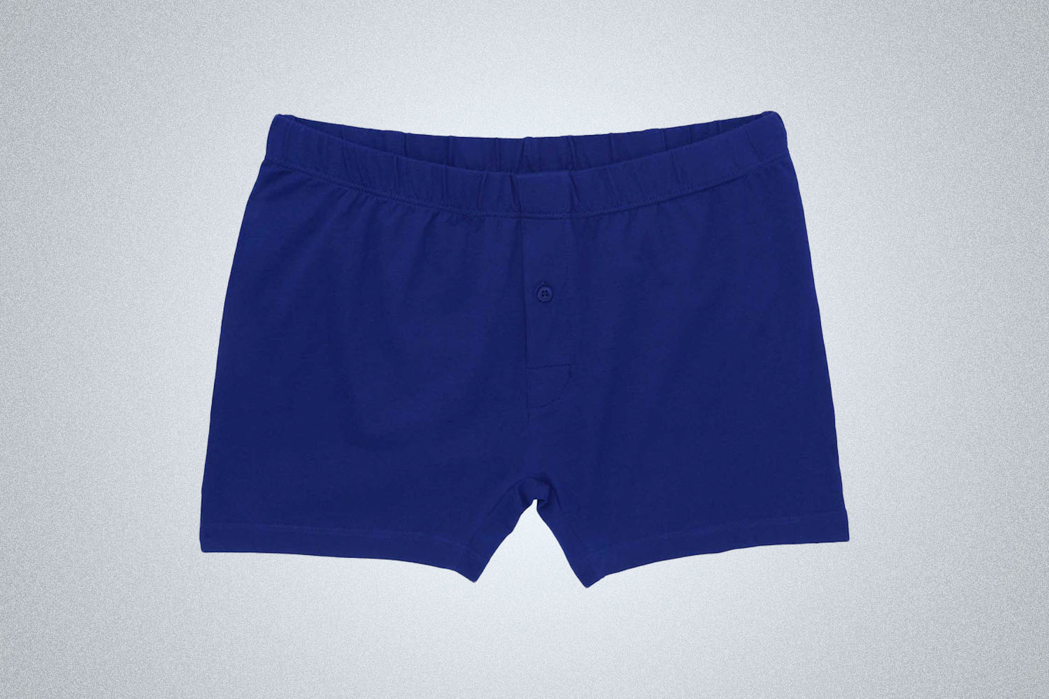 a pair of blue trunks on a grey background