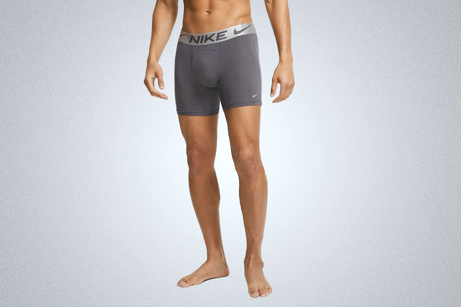 a model in a pair of Nike modal boxer briefs in gray on a gray background