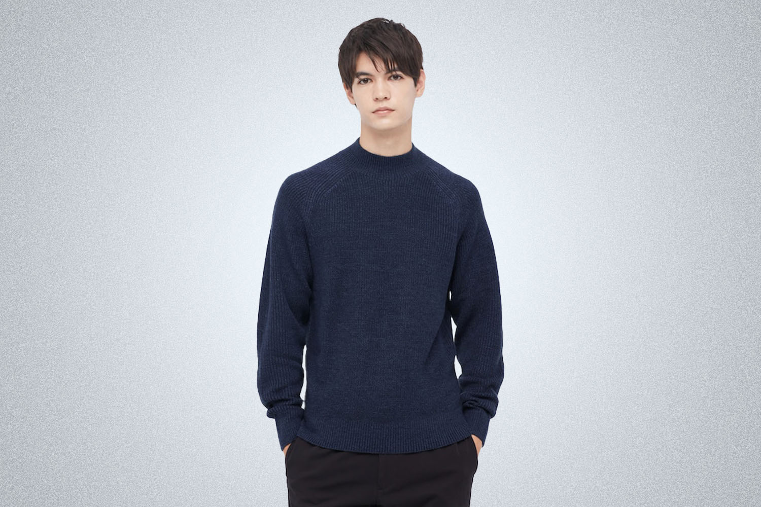 a model in a blue Uniqlo sweater