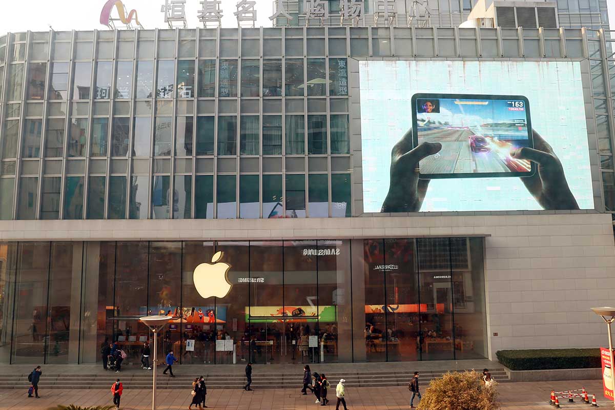 Customers shop at apple's flagship store for smart products on Nanjing Road pedestrian street in Shanghai, China