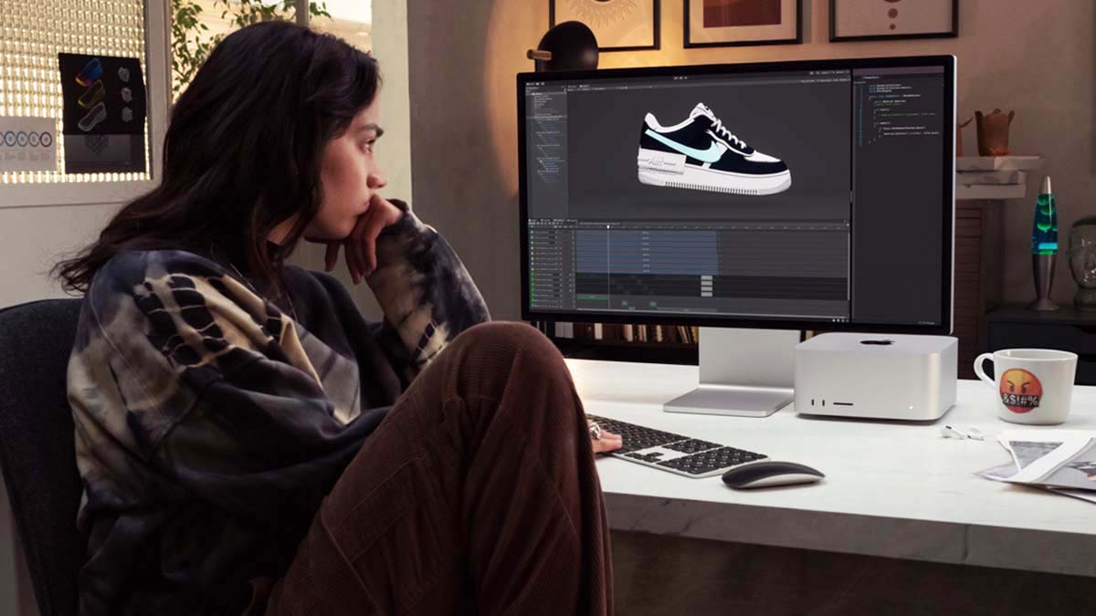 a person at a desk using the new Mac Studio and Studio Display, all of which are on sale during preorders