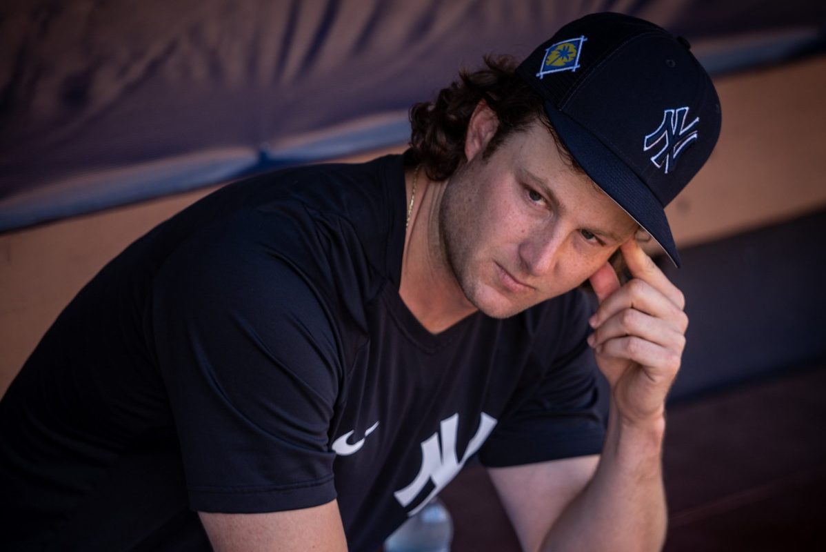 Gerrit Cole sitting in the dugout during a spring training game in Tampa. MLB oddsmakers have said Cole will be the best pitcher in 2022, but here's why that's a mistake.