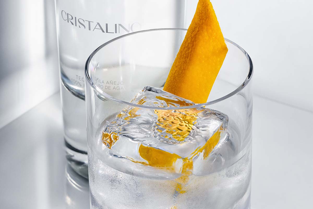 A cocktail made from Avión Reserva Cristalino with a slice of orange peel