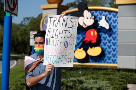 man with pro-trans sign in front of Walt Disney World