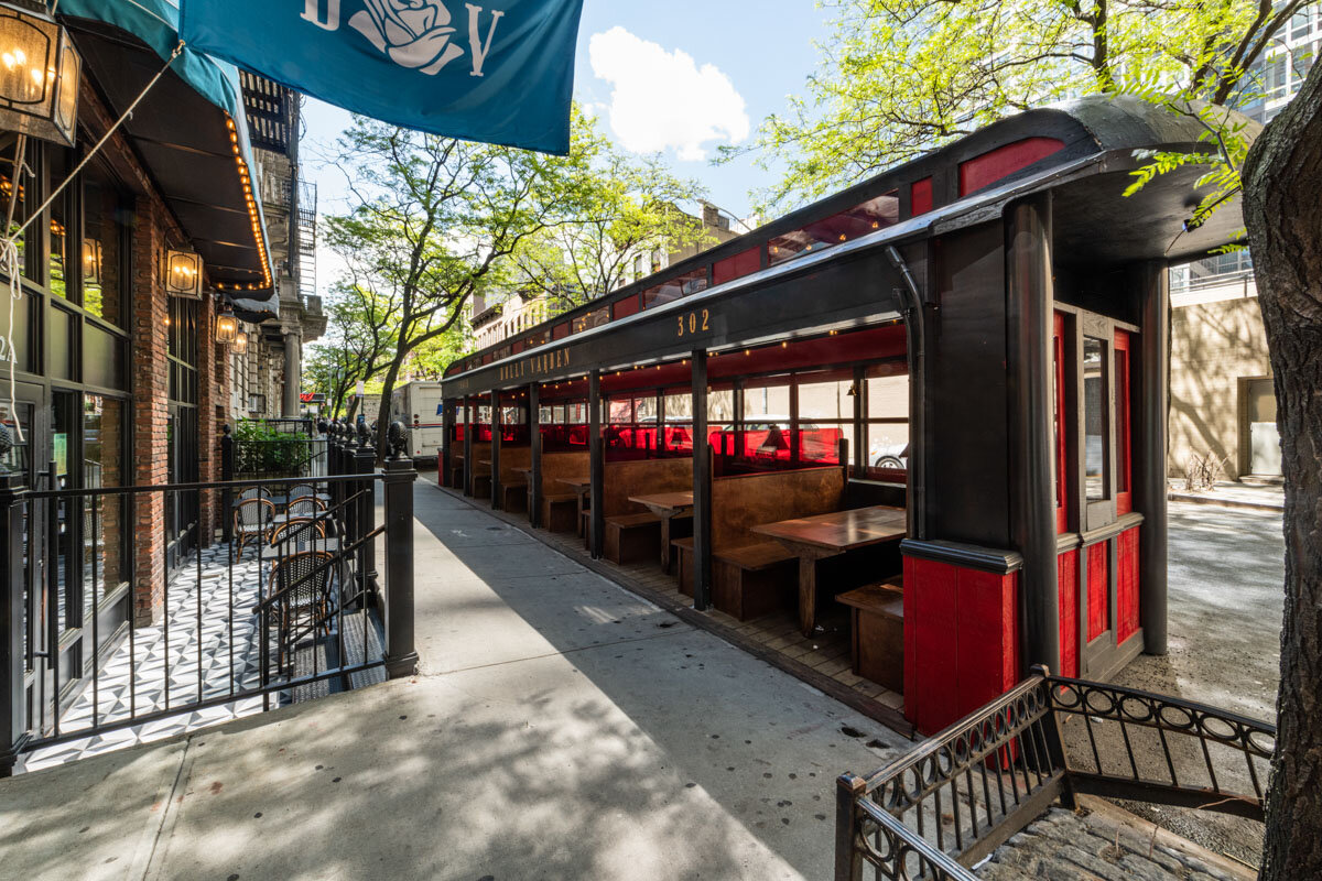The elegant, train-car-themed outdoor dining patio at Dolly Varden