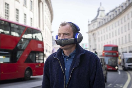 A man wearing the Dyson Zone, a new hybrid of headphones and a portable air purifier