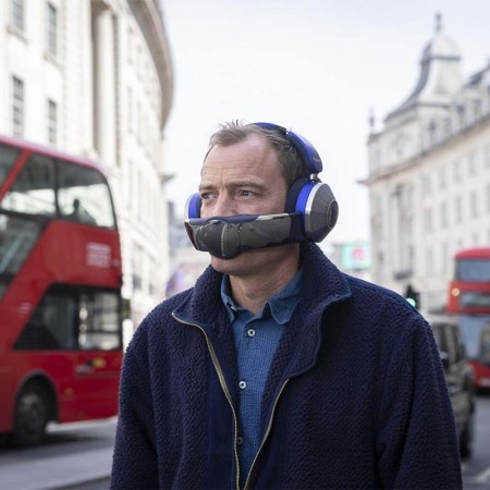 A man wearing the Dyson Zone, a new hybrid of headphones and a portable air purifier