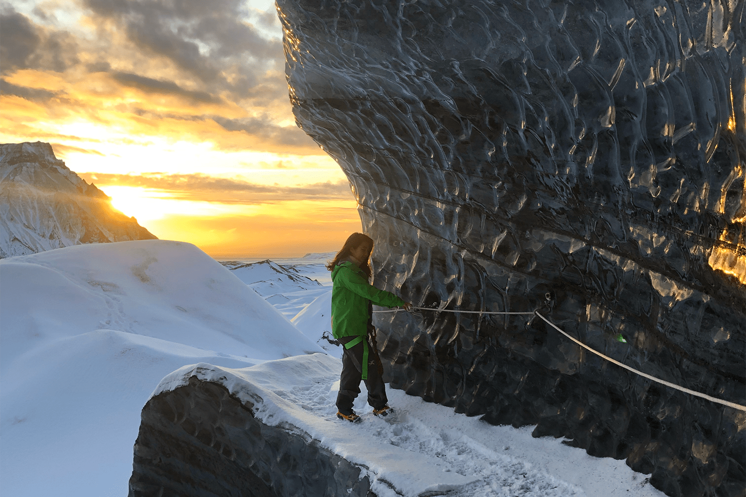 A woman hiking on a glacier in Iceland. We put together an itinerary for those looking to visit Iceland in the off-season.