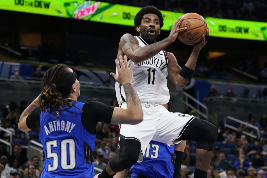 Kyrie Irving of the Nets drives to the basket against the Orlando Magic