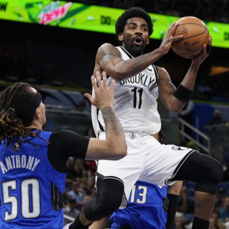 Kyrie Irving of the Nets drives to the basket against the Orlando Magic