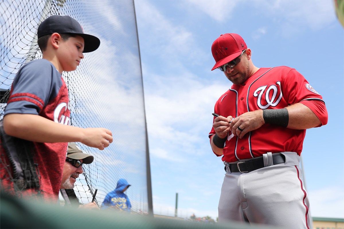 Washington Nationals infielder Jake Noll (13) signs autographs for kids before the Spring Training game between the Washington Nationals and the St. Louis Cardinals on Friday, March 25, 2022 at Roger Dean Chevrolet Stadium in Jupiter, Florida