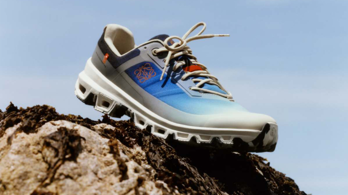 A shoe from the On x Loewe running collection sitting on a rock. We take a look at the Cloudventure shoe and the other gear.