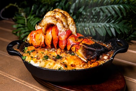 A seafood fish in a cast iron pan from Playa, one of our favorite new restaurants to open in Miami, Florida in 2022