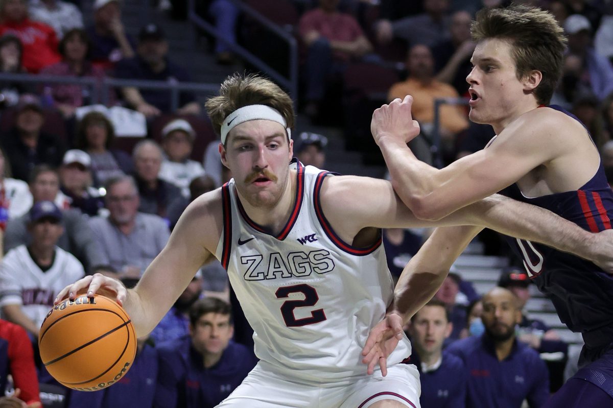 Drew Timme of the Gonzaga Bulldogs is fouled by Mitchell Saxen of the Saint Mary's Gaels
