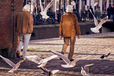 Two white-haired men walking across a square. Here's why ageism can have such a detrimental effect on your lifespan.