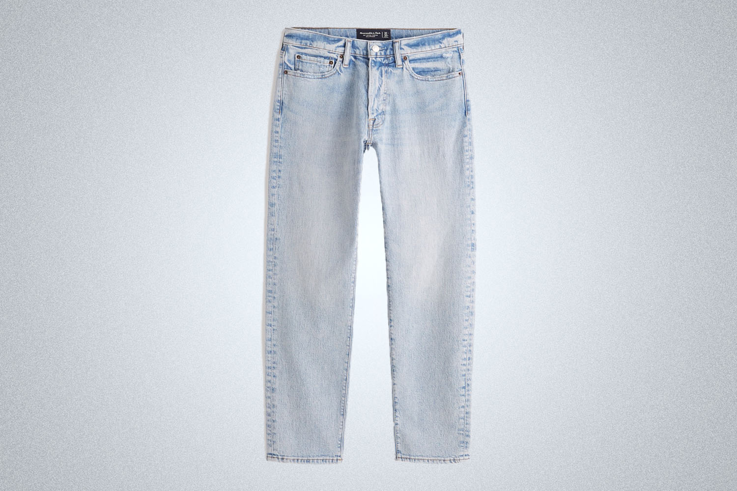 a pair of lightwash jeans from Abercrombie on a grey background