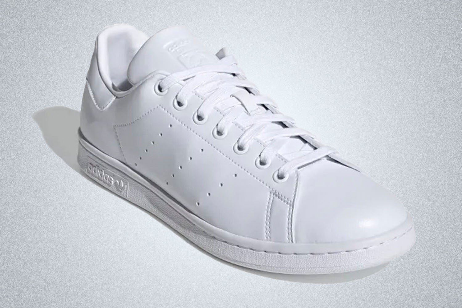 an all white Adidas Stan Smith sneaker on a white background