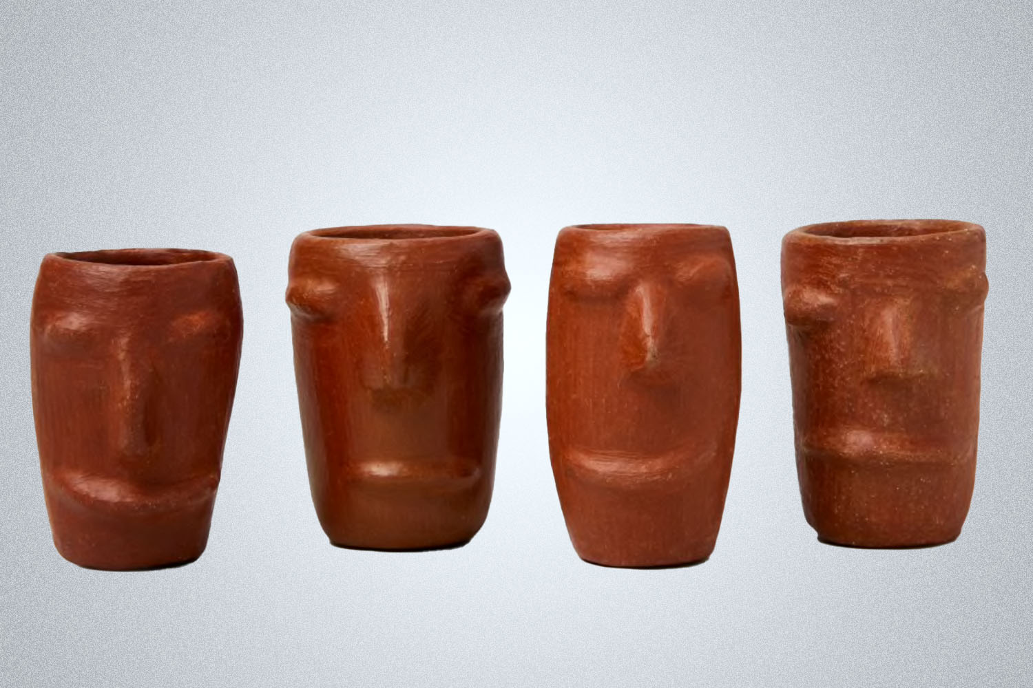 four mescal cups with faces