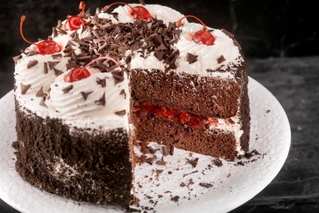 A black forest cake with a large slice cut out