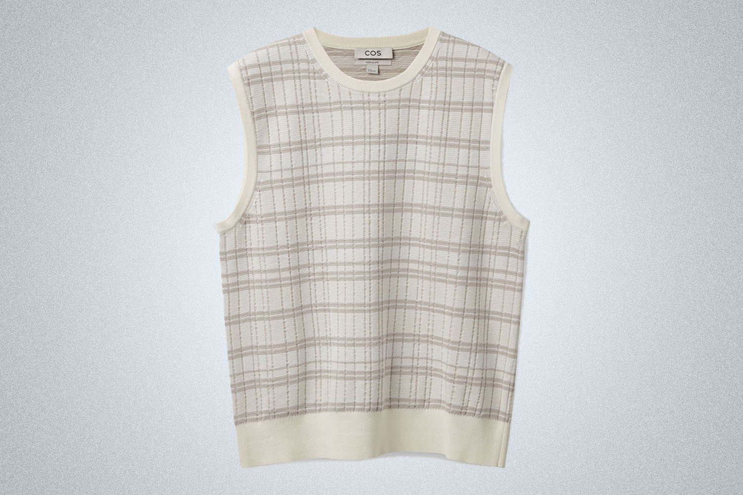 a beige sweater vest from COS on a grey background