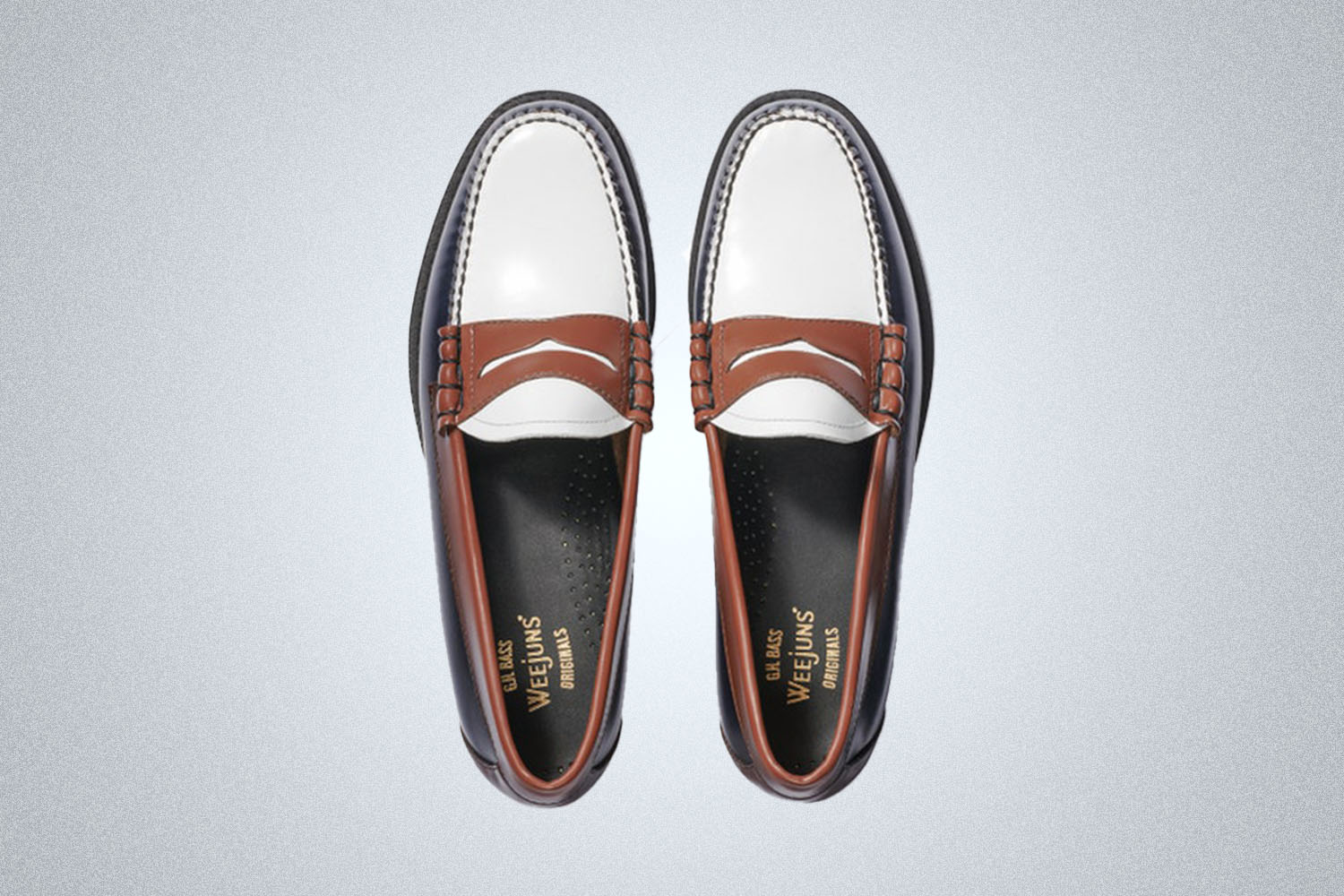 A pair of three-toned G.H. Bass Weejun Loafers on a grey background