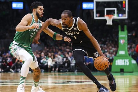 Kevin Durant of the Brooklyn Nets drives to the basket past Jayson Tatum of the Boston Celtics
