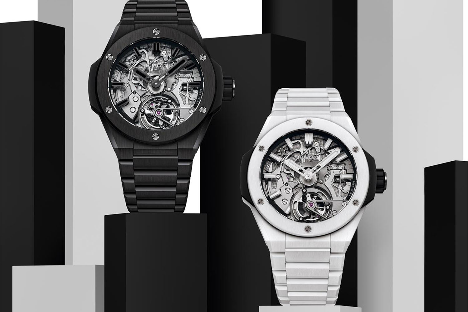 Two Hublot Watches on a black, grey, and white background 
