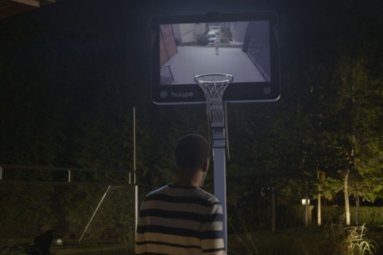a boy standing in front of a electric hoop