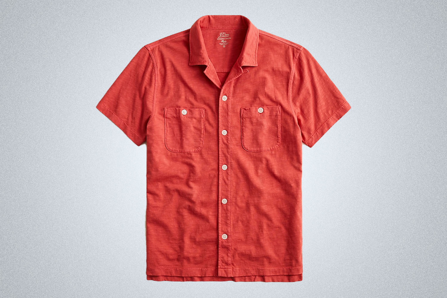 a bright red camp collar shirt from J.Crew on a grey background