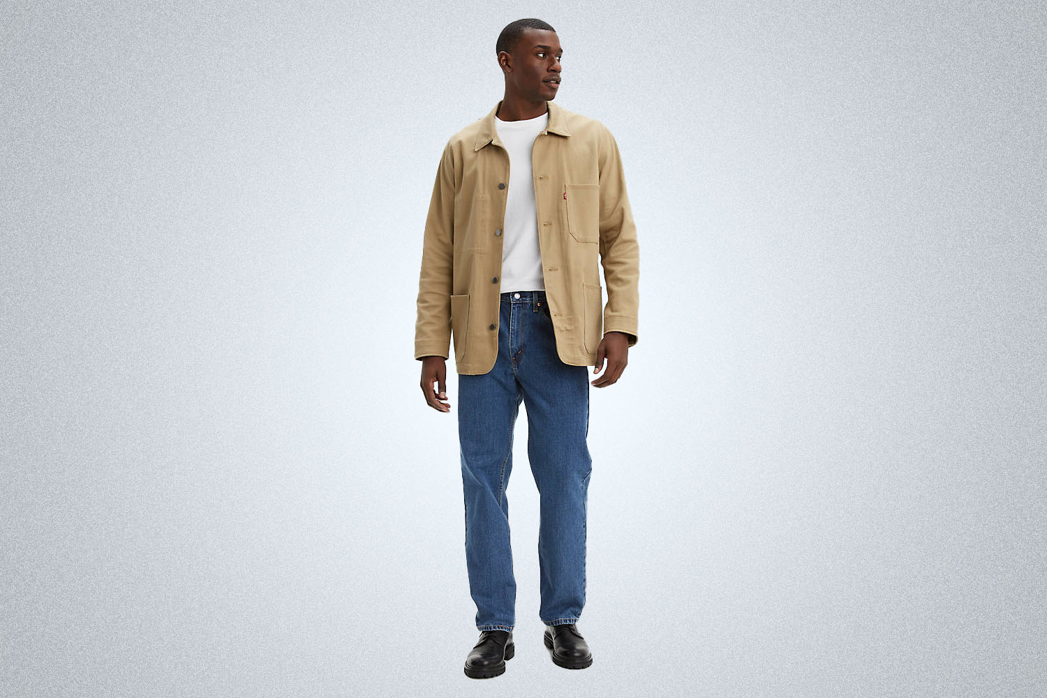 a model wearing medium wash Levi's 550 Relaxed Jeans on a grey background