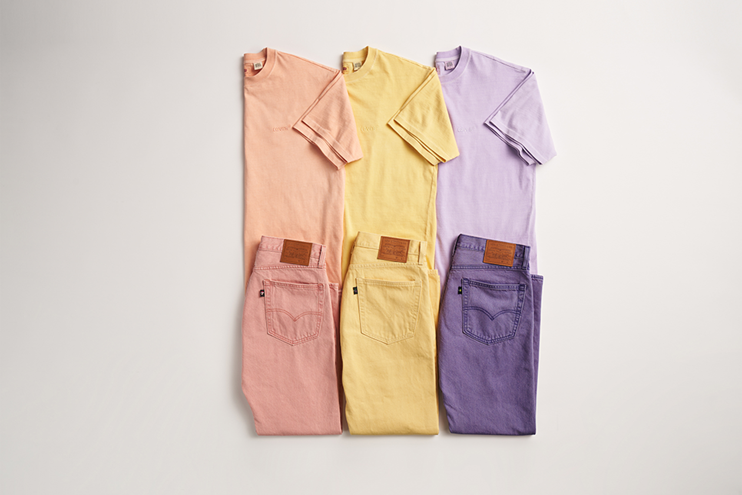 a set of three Levi's tees and jeans in floral spring colors
