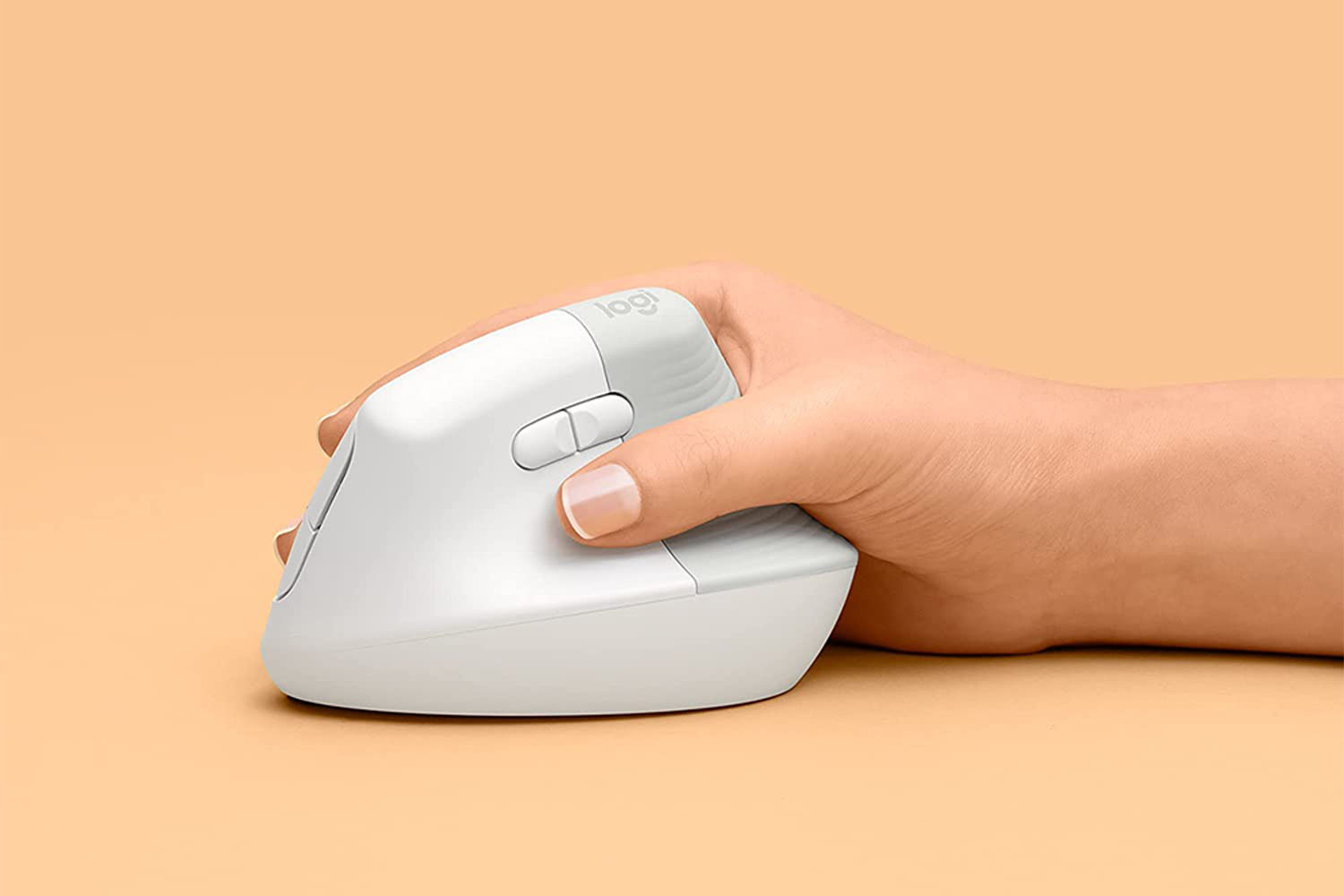 a hand holding a Logitech mouse